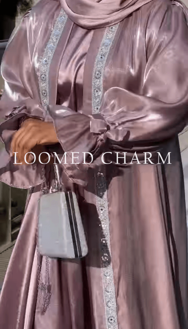 Luxurious Noya Silk Organza Shrug Abaya in soft pink with intricate crystal embellishments, featuring a satin inner, adjustable belt, and matching white chiffon scarf.