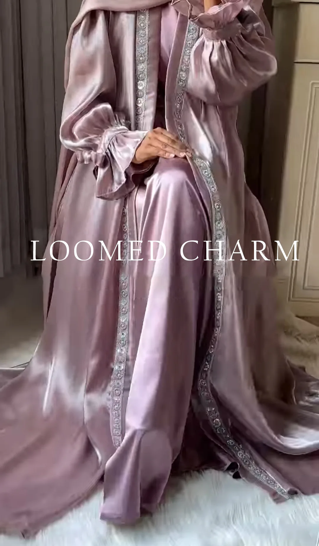 Luxurious Noya Silk Organza Shrug Abaya in soft pink with intricate crystal embellishments, featuring a satin inner, adjustable belt, and matching white chiffon scarf.