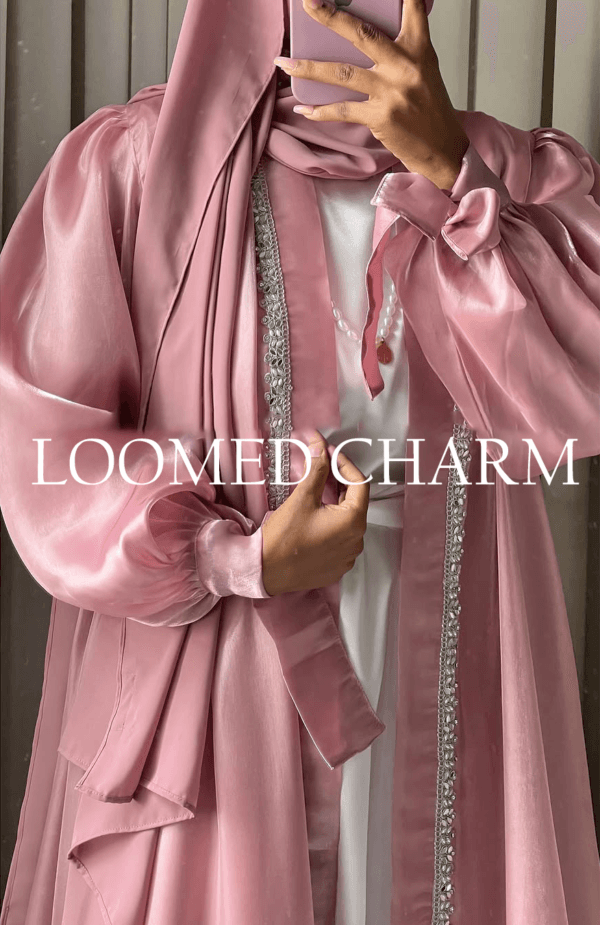 Luxurious Noya Silk Organza Shrug Abaya in soft pink with intricate crystal embellishments, featuring a satin inner, adjustable belt, and matching white chiffon scarf.