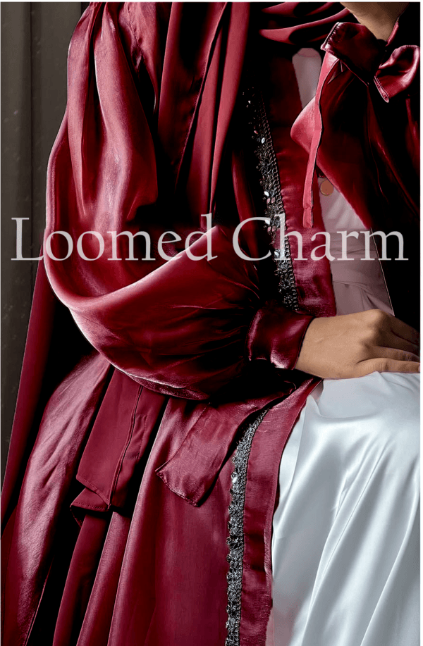Luxurious Noya Silk Organza Shrug Abaya in soft pink with intricate crystal embellishments, featuring a satin inner, adjustable belt, and matching white chiffon scarf.