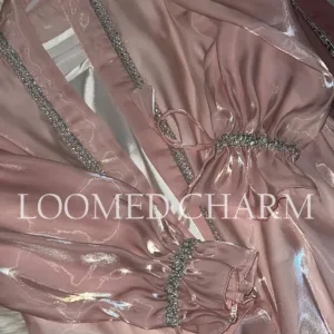Luxurious Noya Silk Organza Shrug Abaya in soft pink with intricate crystal embellishments, featuring a satin inner, adjustable belt, and matching white chiffon scarf.