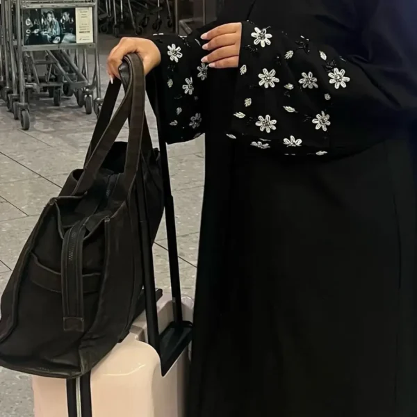 Zeenat Abaya in premium Korean Nida fabric with floral embroidery on sleeves, front-open button design, and a free matching scarf. Available in black, white, pink, teal, navy blue, and bottle green.
