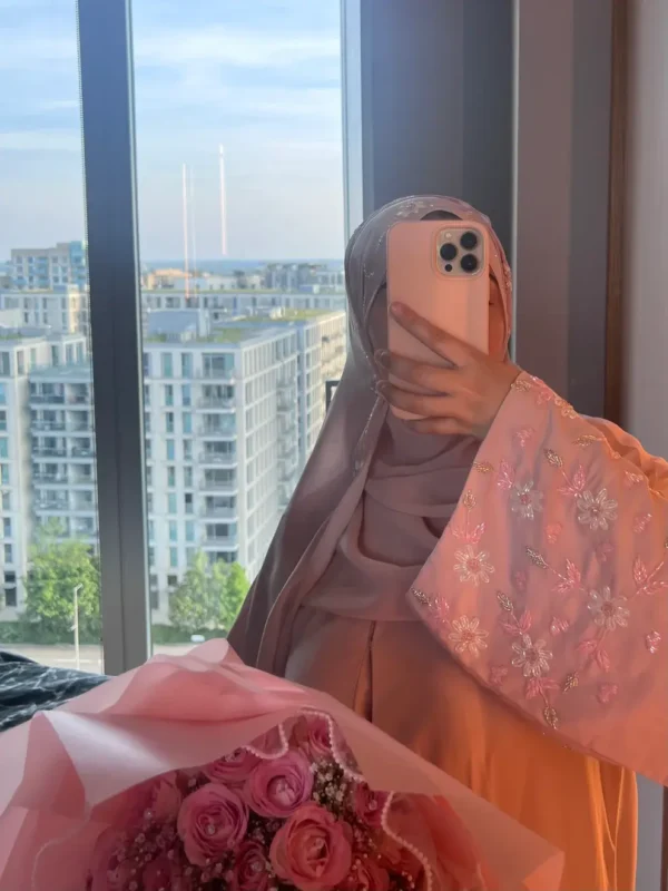 Zeenat Abaya in premium Korean Nida fabric with floral embroidery on sleeves, front-open button design, and a free matching scarf. Available in black, white, pink, teal, navy blue, and bottle green.