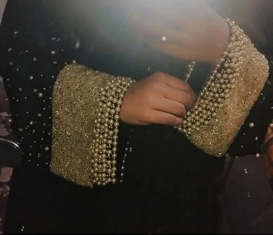 Pearl and diamond embellished gold cuff on black luxury abaya
